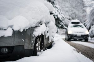 Snow-covered street and car