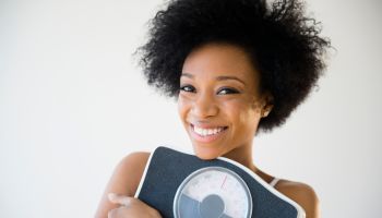 African American woman holding scale