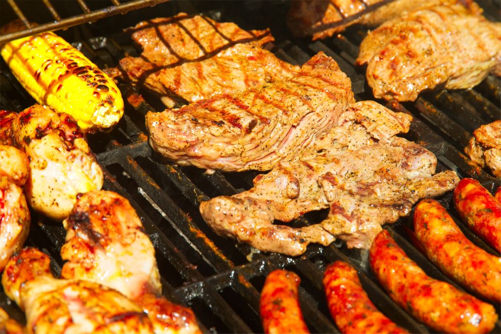 Barbecue grill with chicken, stakes, chorizo, corn and arepas, make a traditional Colombian barbecue