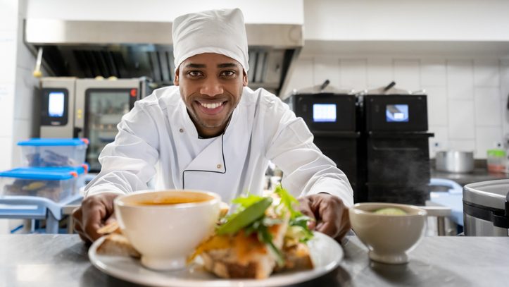 Chef serving a plate at a restaurant