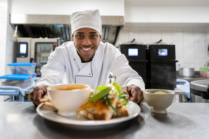 Chef serving a plate at a restaurant