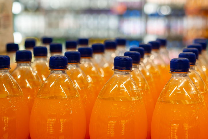Refreshing Orange Beverage Bottles Lined Up Neatly